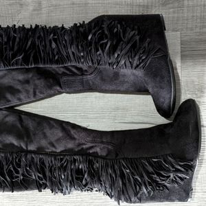 Black suede wedge heel boots with fringe